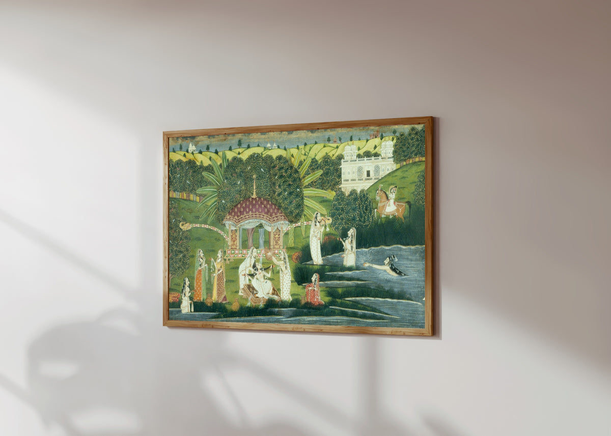 Framed art print of Bani Thani Bathing at Pholl Sagar Palace by Kishangarh school, in a light wood frame on a sunlit white wall, seen at a slight angle