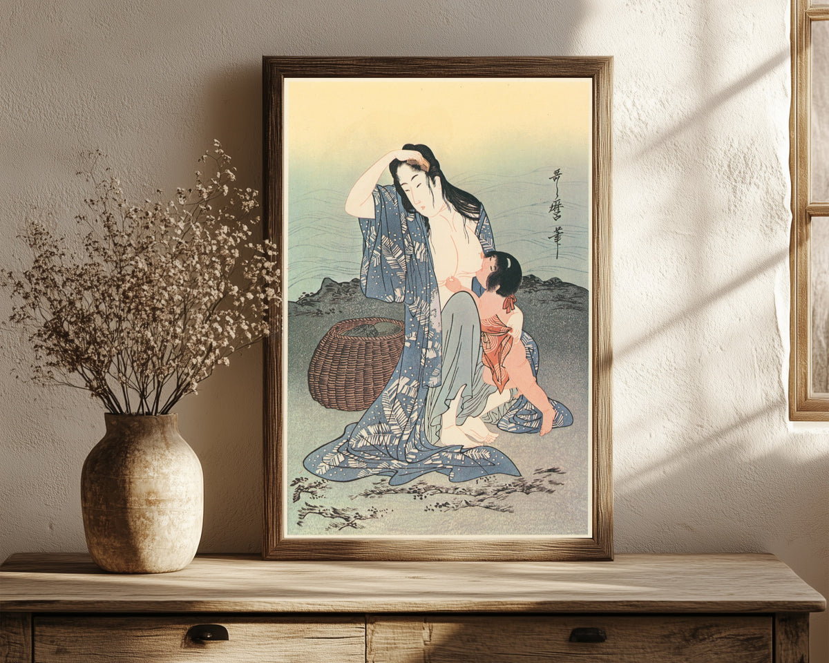 Framed art print of Diving for Abalones (Center) by Kitagawa Utamaro, in a dark wood frame leaning on a rustic console beside dried flowers