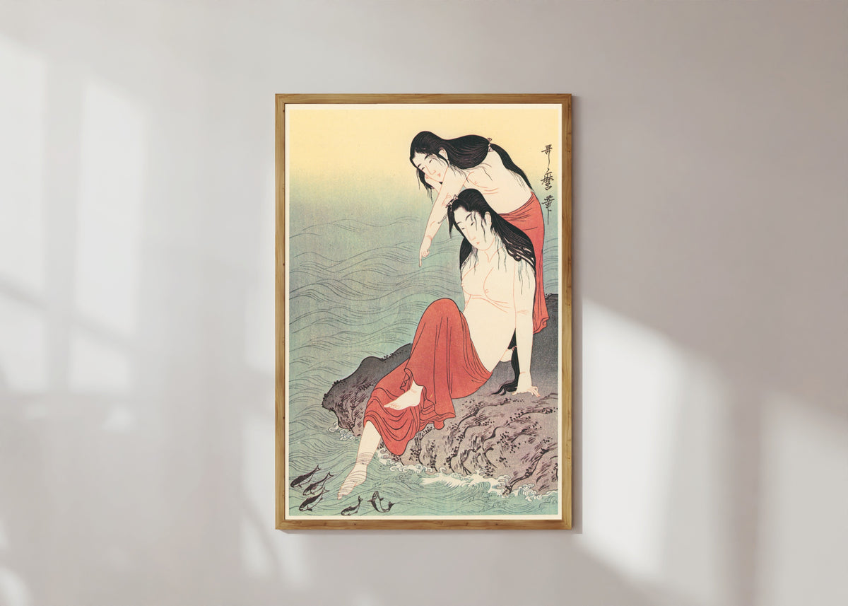 Framed art print of Diving for Abalones (Left) by Kitagawa Utamaro, in a light wood frame on a sunlit white wall