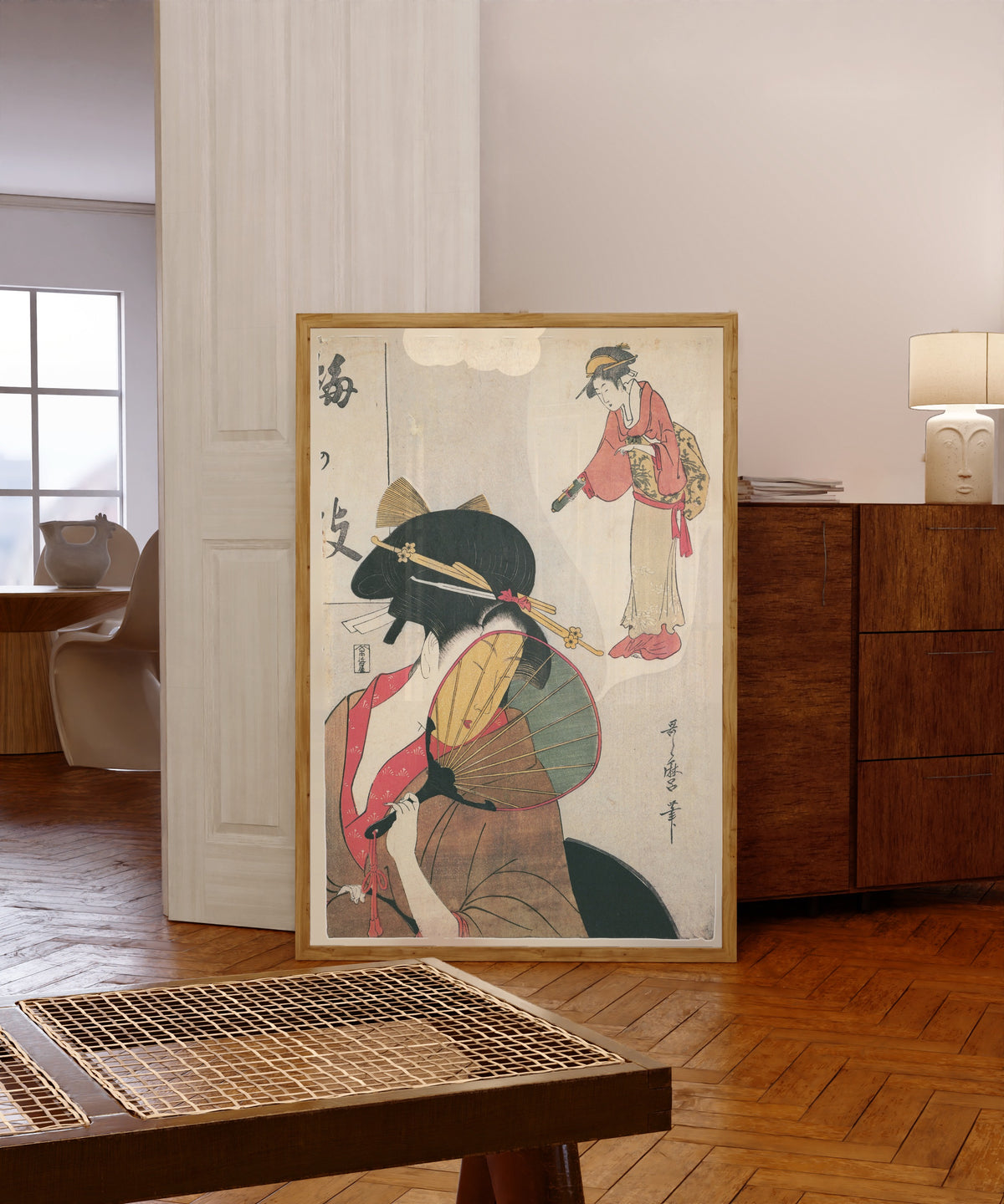 Framed art print of Dreaming Beauty (Umegae) by Kitagawa Utamaro, in a light wood frame leaning in a warm room with a parquet floor
