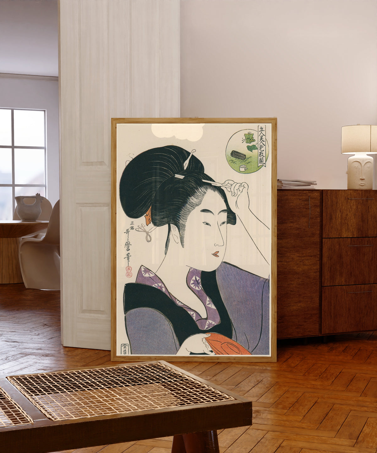 Framed art print of Five Beauties in a Contest of Attractiveness by Kitagawa Utamaro, in a light wood frame leaning in a warm room with a parquet floor