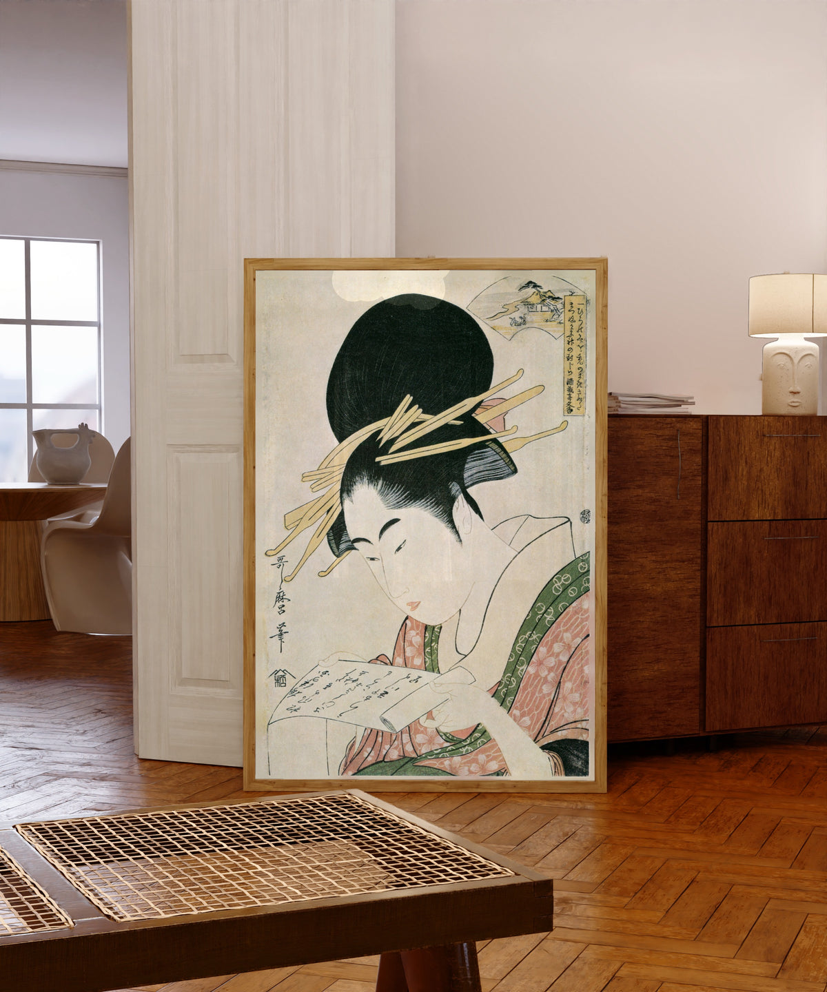 Framed art print of Kinuta Jewel River, from Six Jewel Rivers by Kitagawa Utamaro, in a light wood frame leaning in a warm room with a parquet floor