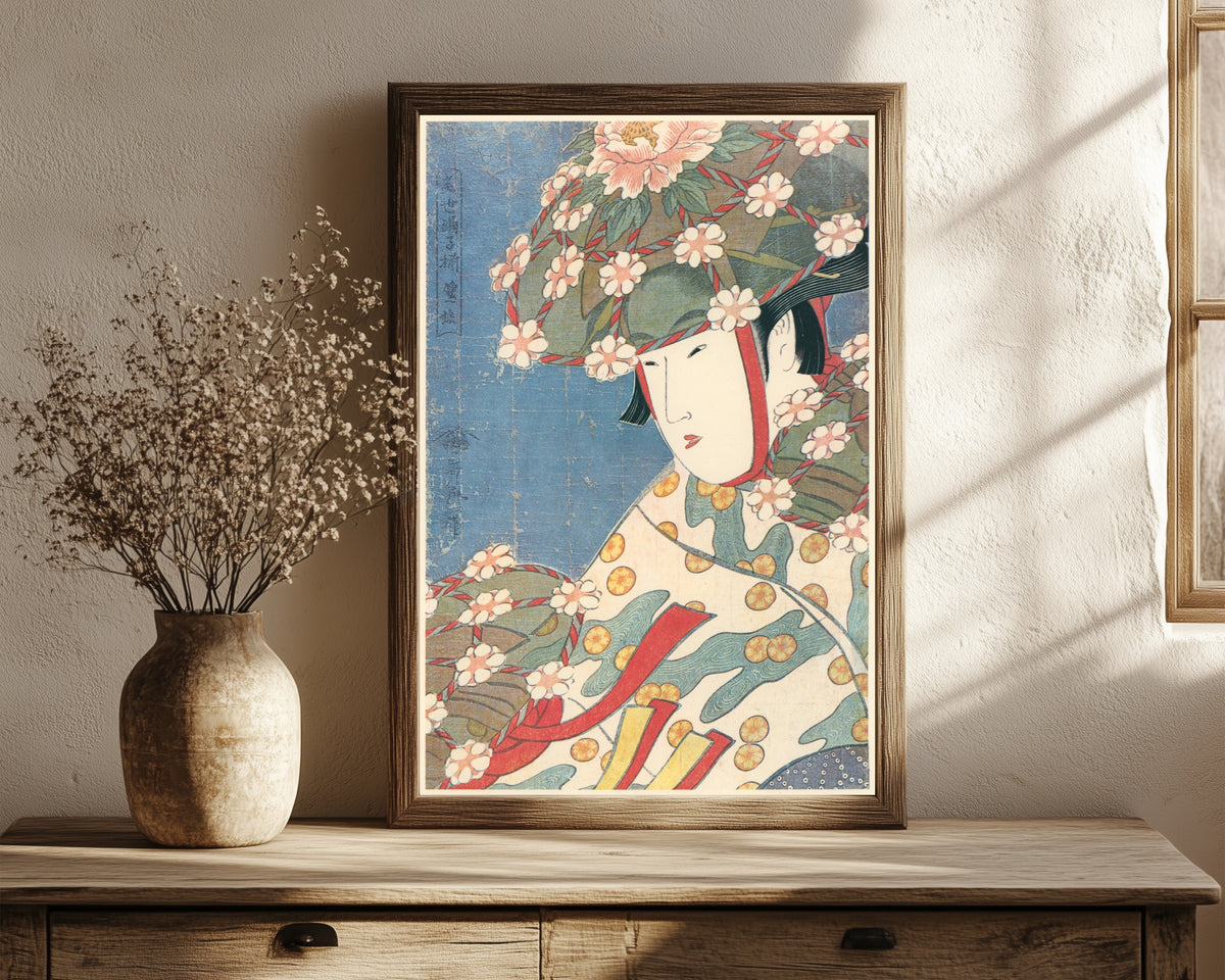 Framed art print of Modern Dancers – Heron Girl by Kitagawa Utamaro, in a dark wood frame leaning on a rustic console beside dried flowers