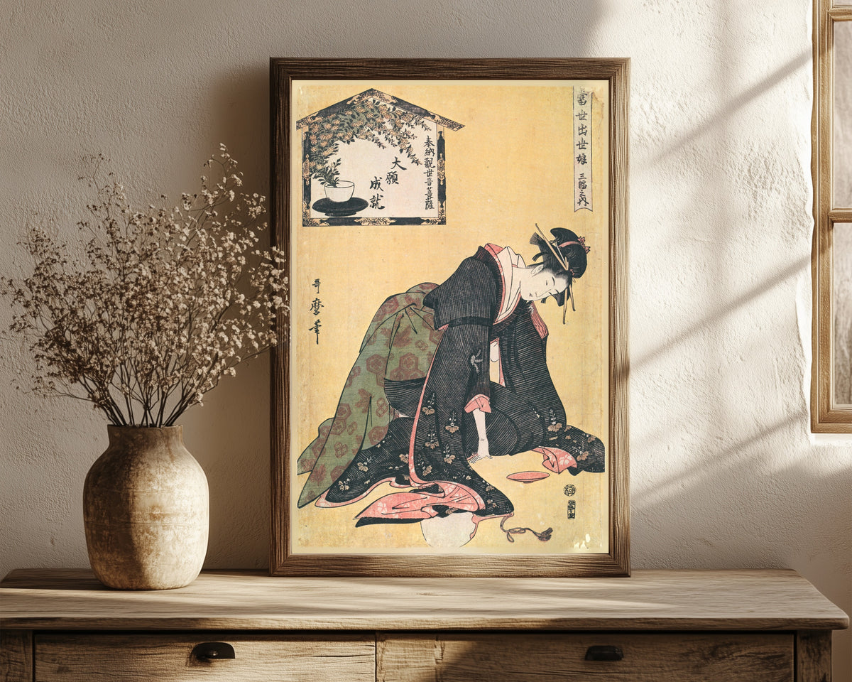 Framed art print of Naniwaya Okita, from Three Successful Girls of… by Kitagawa Utamaro, in a dark wood frame leaning on a rustic console beside dried flowers