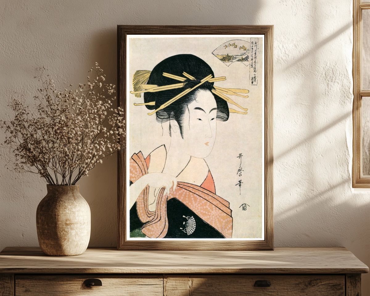 Framed art print of Noda Jewel River by Kitagawa Utamaro, in a dark wood frame leaning on a rustic console beside dried flowers