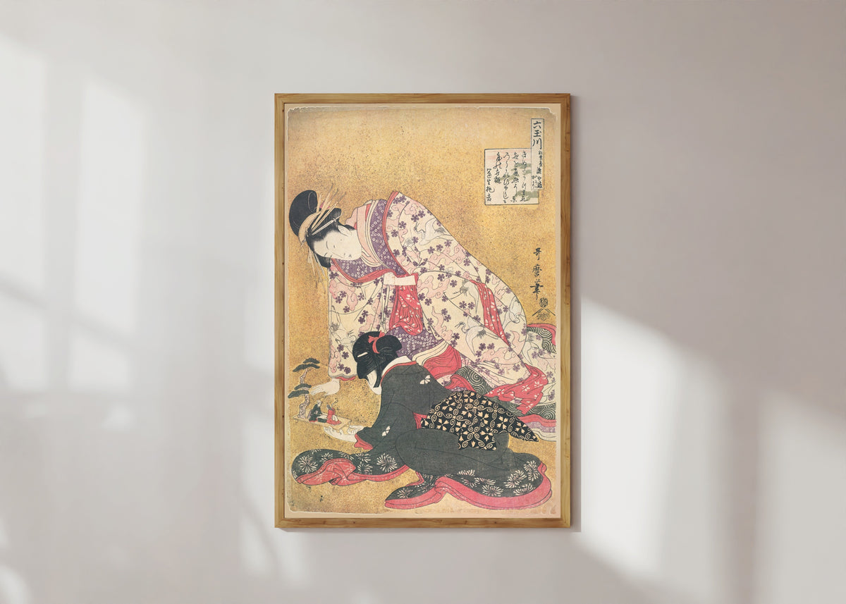 Framed art print of Seyama of the Matsubaya, kamuro Iroka and Yukari, from the series Six… by Kitagawa Utamaro, in a light wood frame on a sunlit white wall