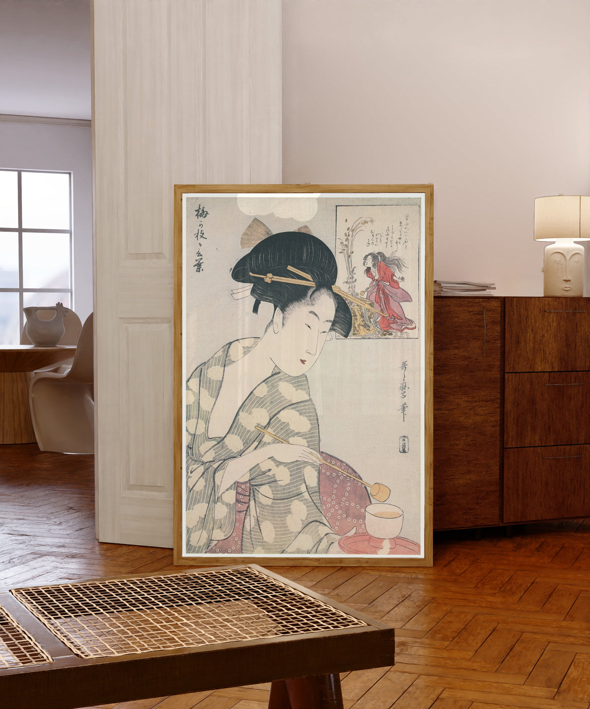 Framed art print of Umegae's Words by Kitagawa Utamaro, in a light wood frame leaning in a warm room with a parquet floor