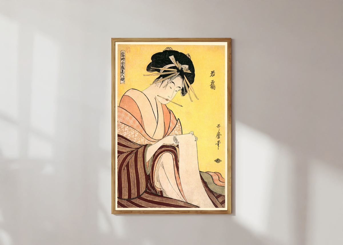 Framed art print of Wakatsuru by Kitagawa Utamaro, in a light wood frame on a sunlit white wall