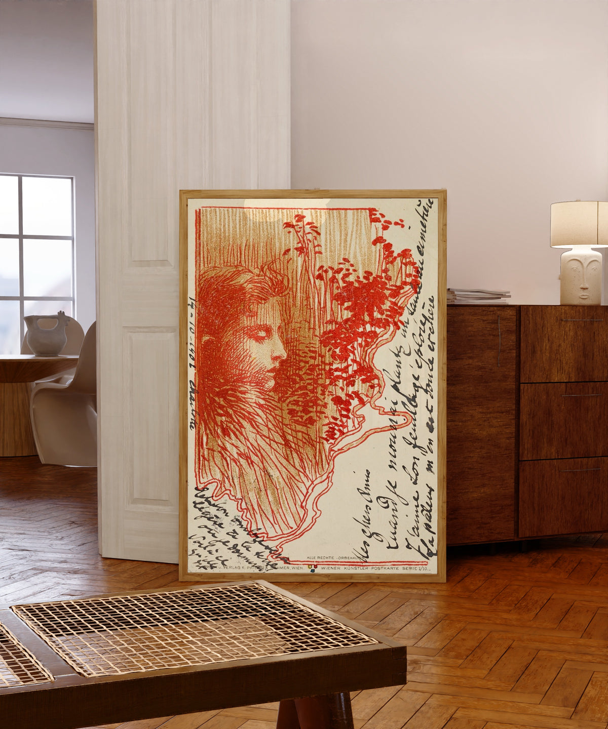 Framed art print of Postcard Sketch by Koloman Moser, in a light wood frame leaning in a warm room with a parquet floor
