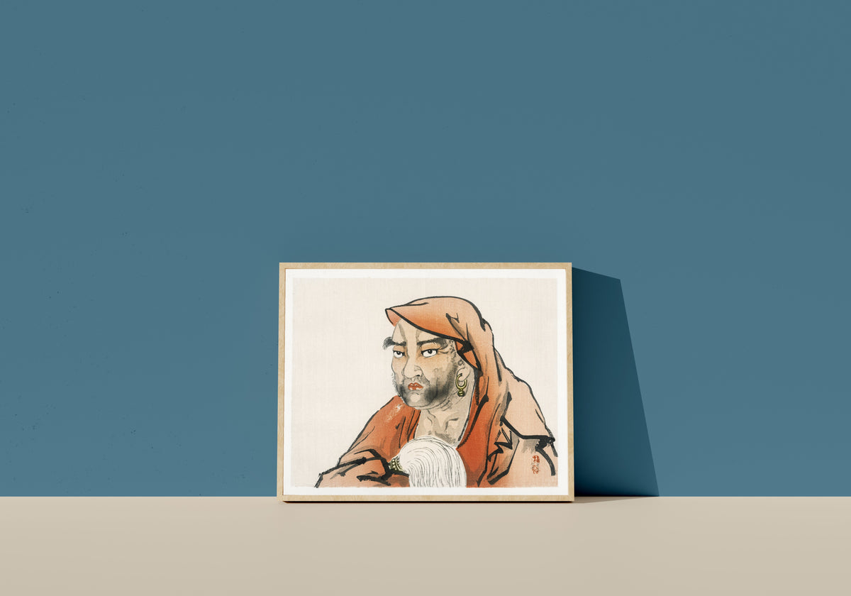 Framed art print of Daruma (Bodhidharma) with a horsetail whisk by Kōno Bairei, in a light wood frame leaning on a blue wall