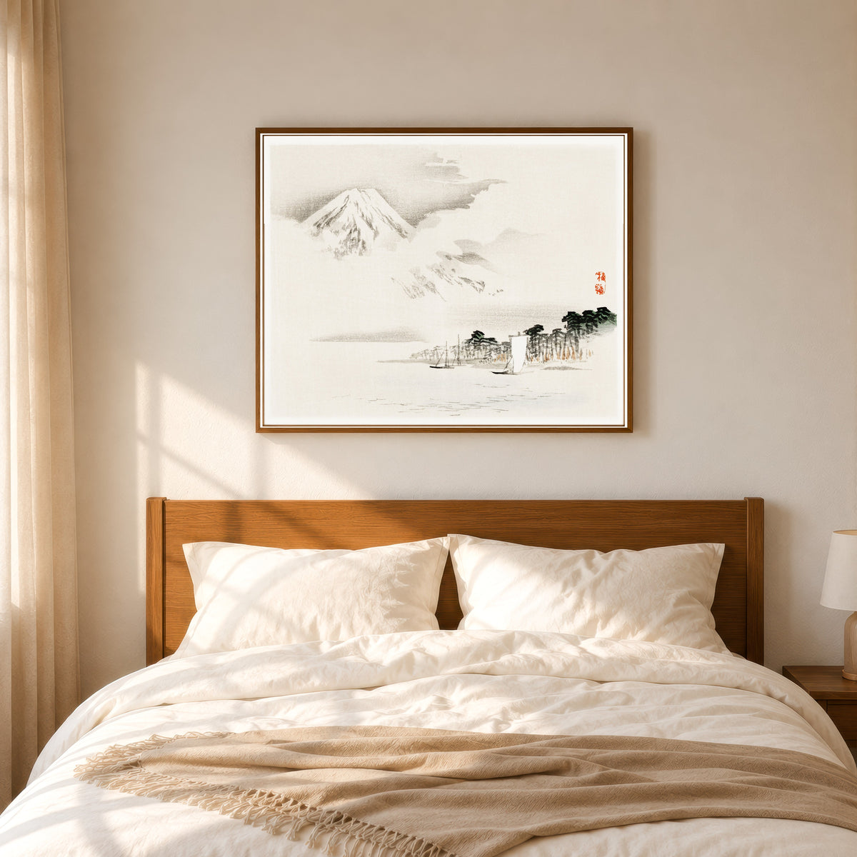 Framed art print of View of Mount Fuji by Kōno Bairei, in a slim wood frame above a bed in a sunlit bedroom