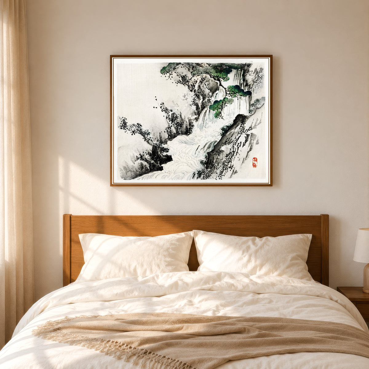 Framed art print of Waterfall by Kōno Bairei, in a slim wood frame above a bed in a sunlit bedroom