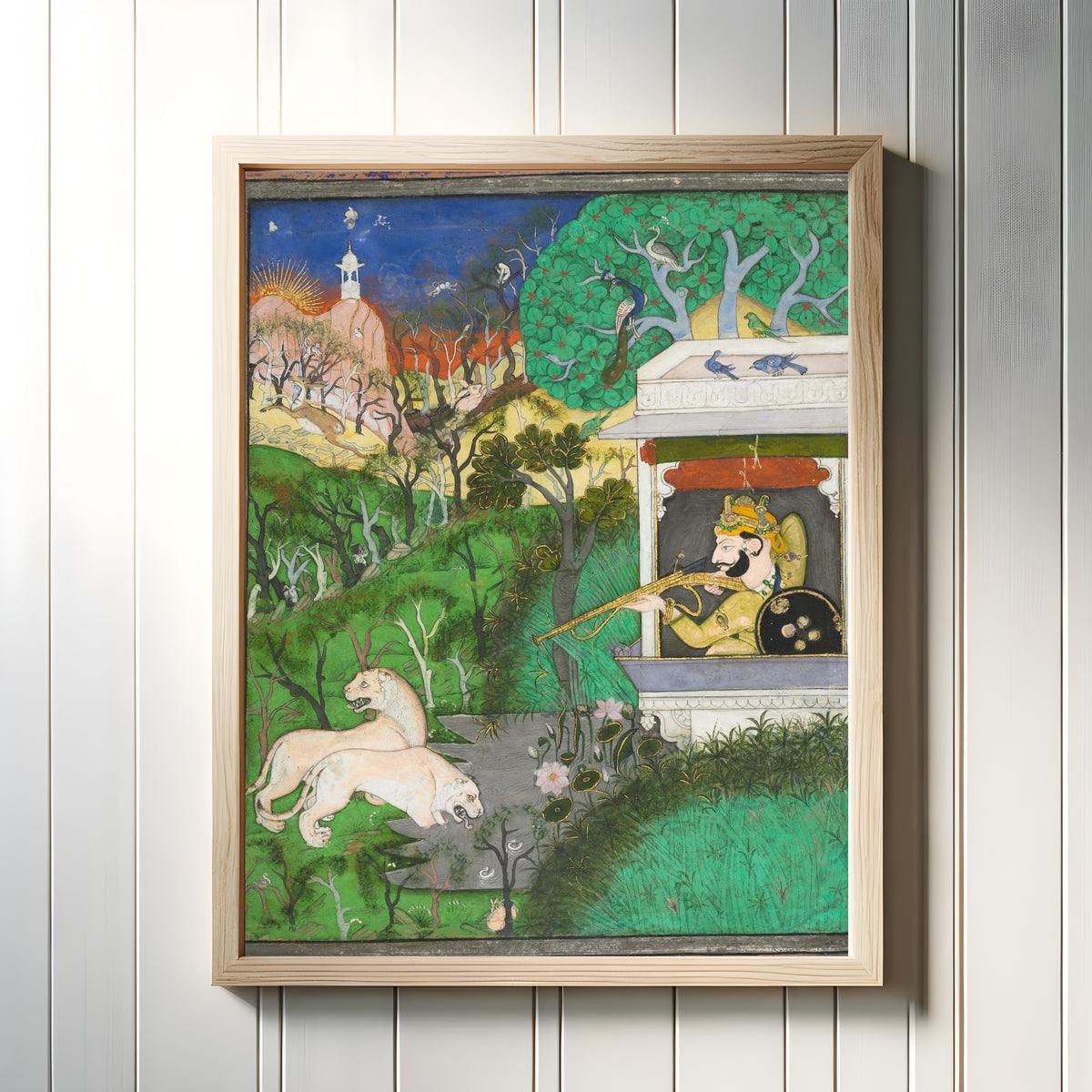 Framed art print of Maharaja Chattarsol of Kota Shooting Lions by Kota school, in a light wood frame on a white panelled wall
