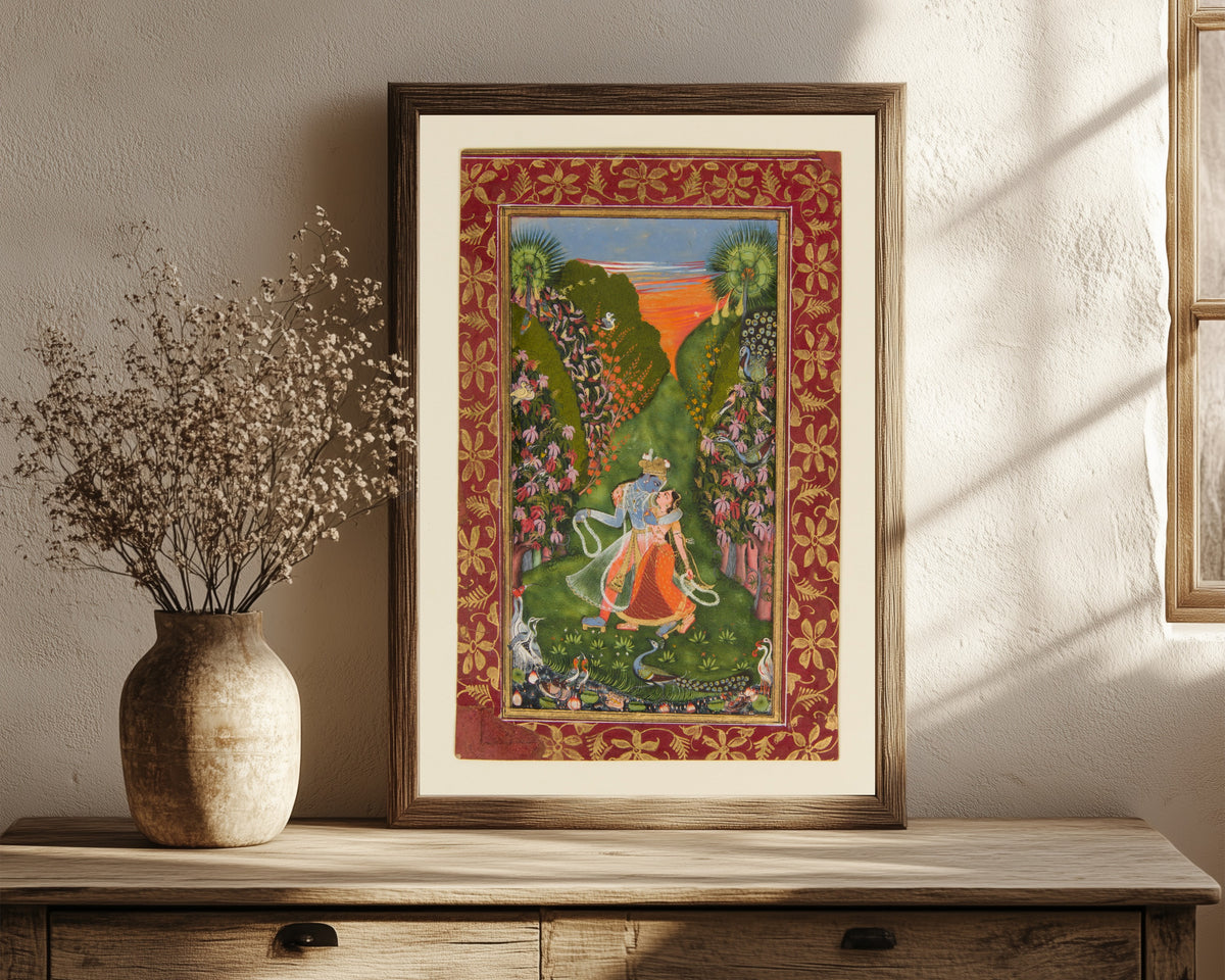 Framed art print of Radha and Krishna Walk in a Flowering Grove by Kota school, in a dark wood frame leaning on a rustic console beside dried flowers