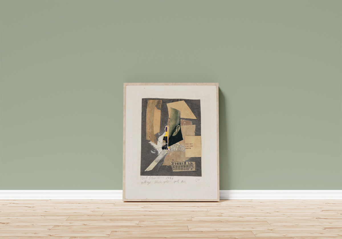 Framed art print of Collage Black Yellow and Ear by Kurt Schwitters, in a light wood frame leaning on a sage green wall above a wooden floor