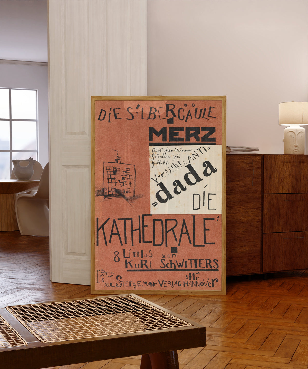 Framed art print of Die Kathedrale (Die Silbergäule) by Kurt Schwitters, in a light wood frame leaning in a warm room with a parquet floor
