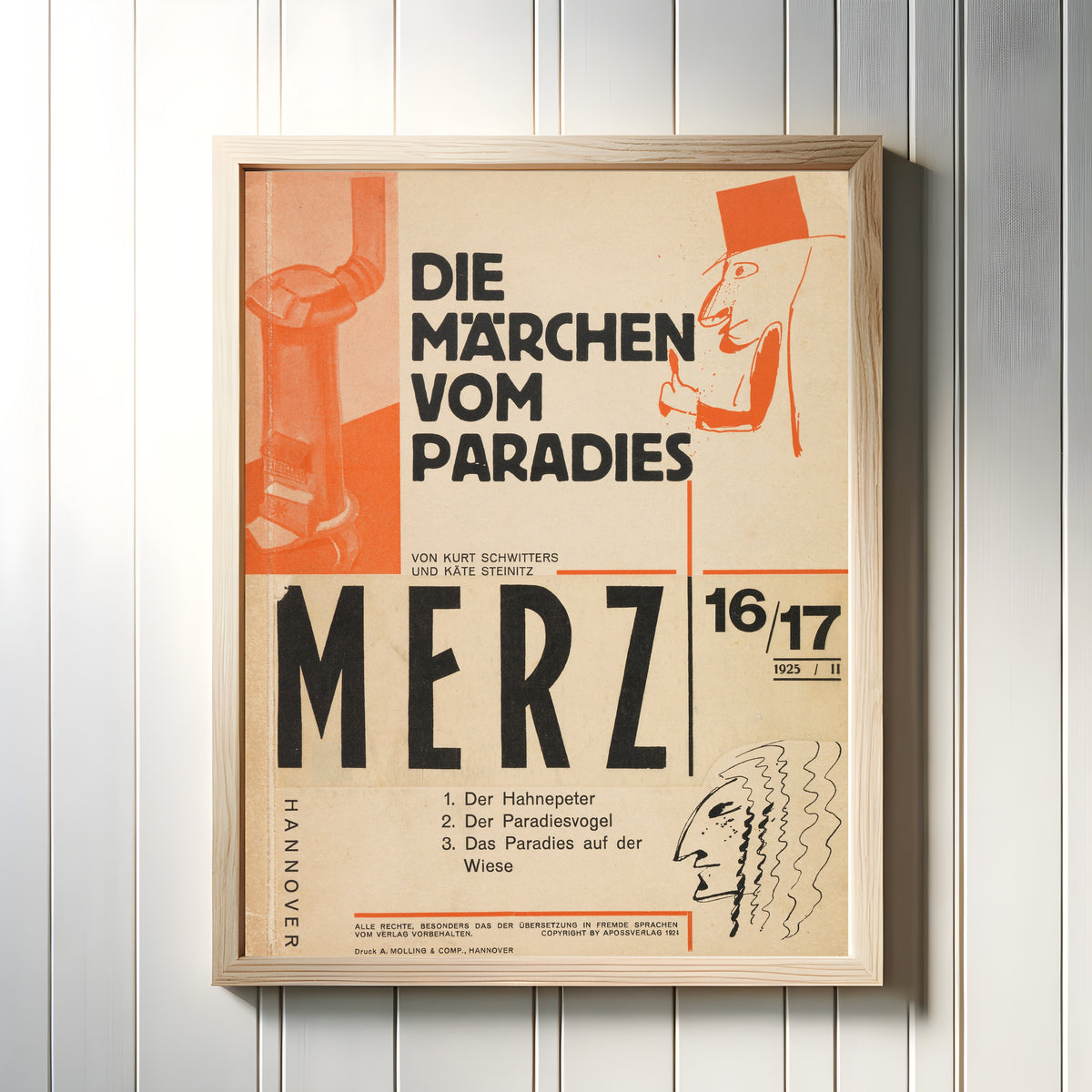 Framed art print of Die Märchen vom Paradies (Merz 16/17) by Kurt Schwitters, in a light wood frame on a white panelled wall