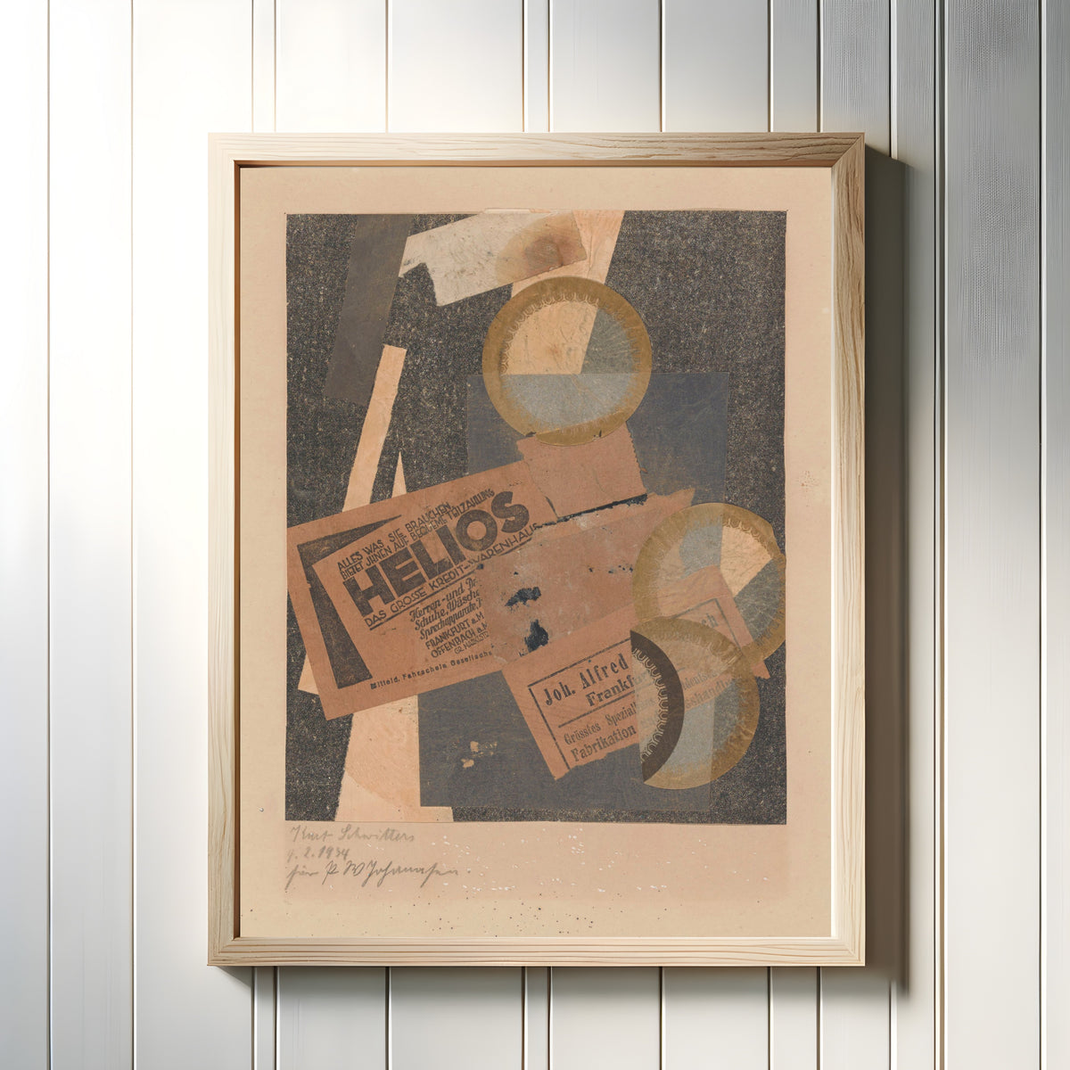 Framed art print of Helios by Kurt Schwitters, in a light wood frame on a white panelled wall