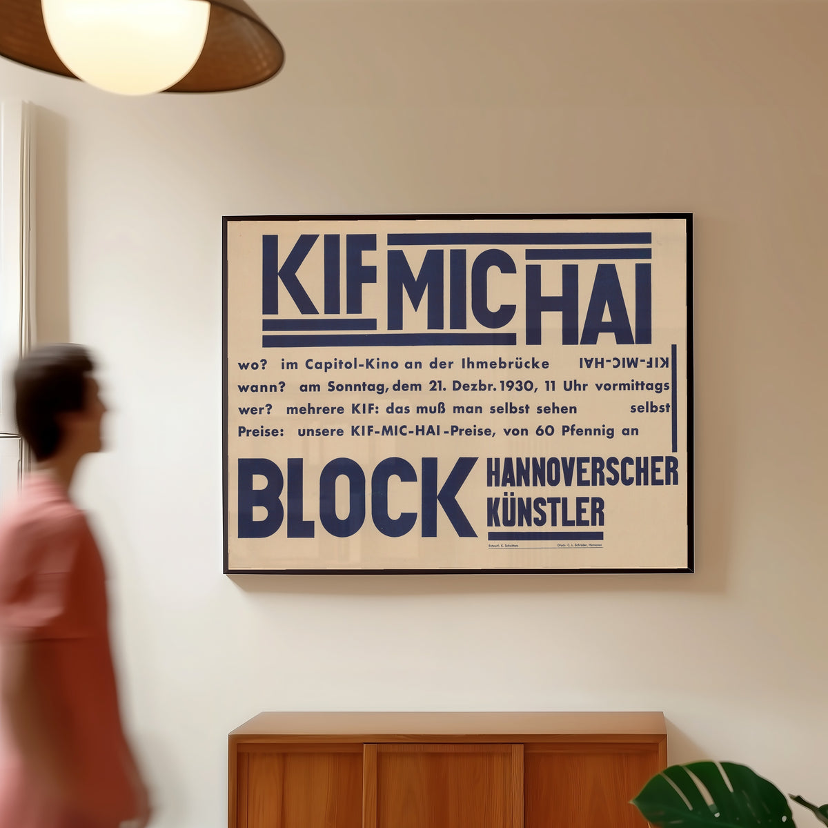 Framed art print of KIF MIC HAI, Block Hannoverscher Künstler by Kurt Schwitters, in a slim black frame on a warm wall in a sunlit room