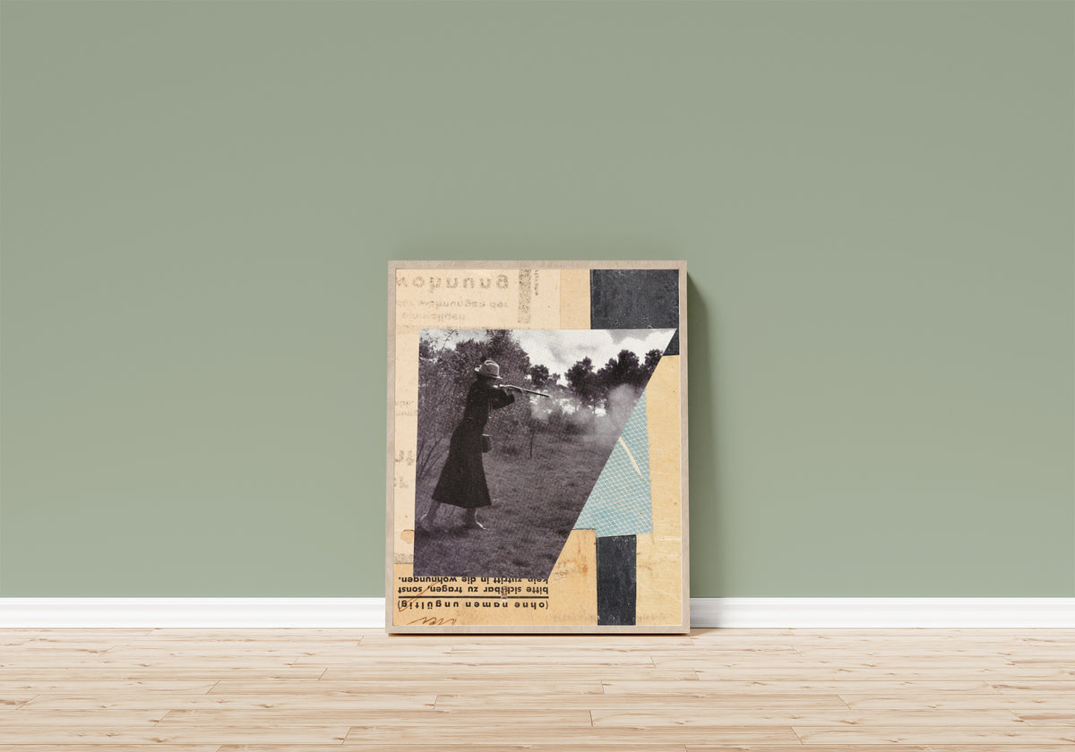 Framed art print of Mit Jägerin, Merzzeichnung by Kurt Schwitters, in a light wood frame leaning on a sage green wall above a wooden floor