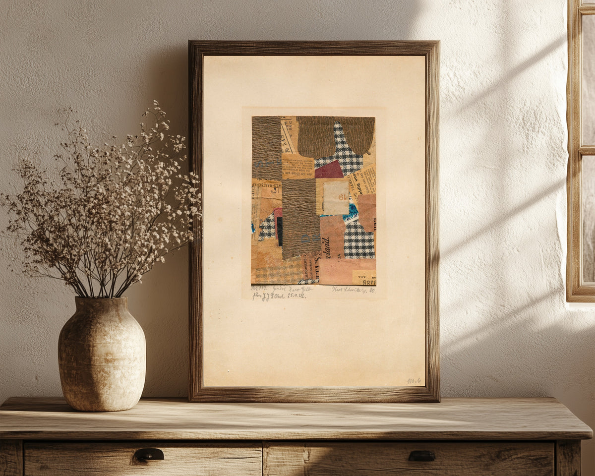 Framed art print of Mz 117. Genève Karo Gelb by Kurt Schwitters, in a dark wood frame leaning on a rustic console beside dried flowers