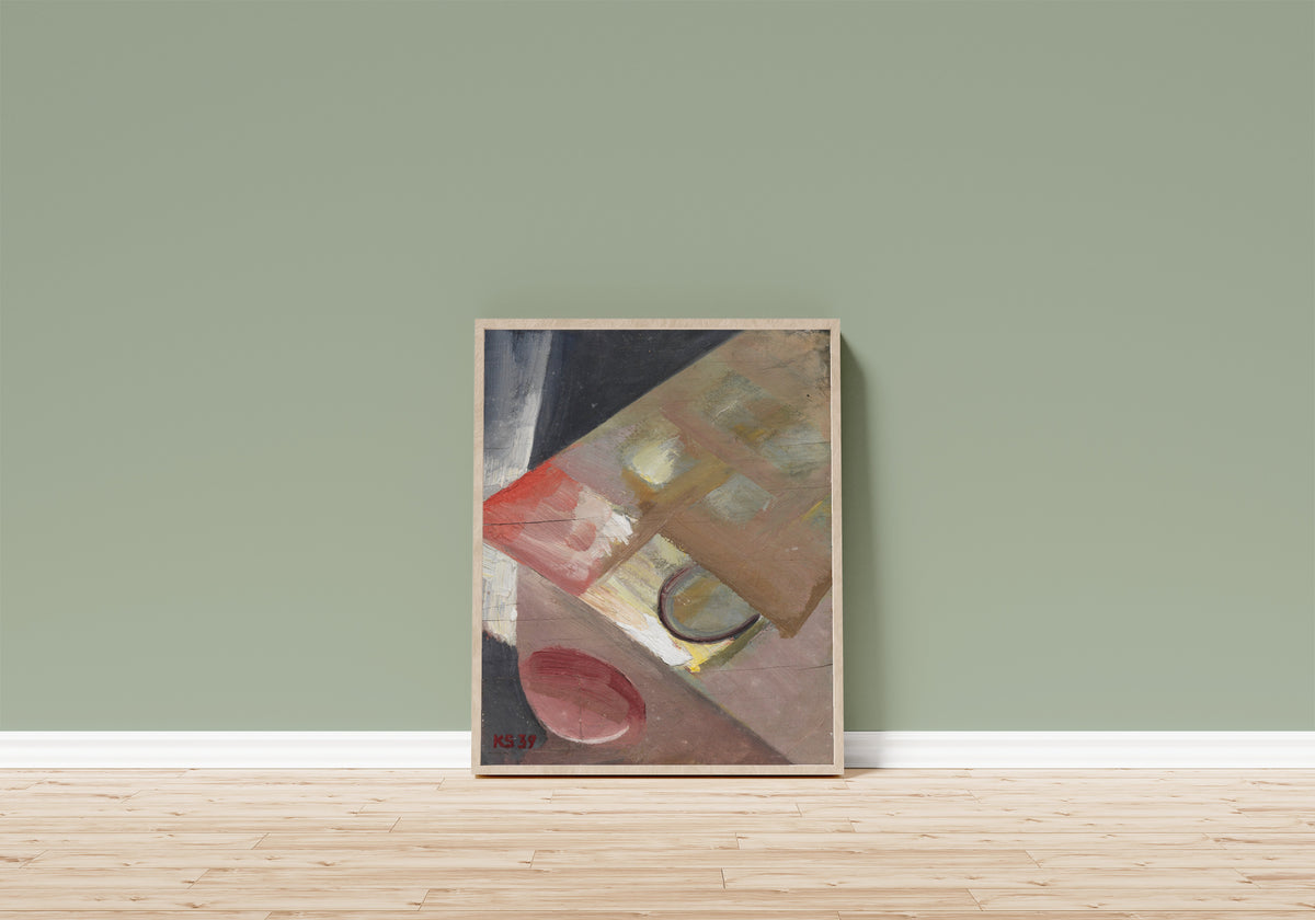 Framed art print of Ohne Titel (Bild mit schiefer Ebene) by Kurt Schwitters, in a light wood frame leaning on a sage green wall above a wooden floor