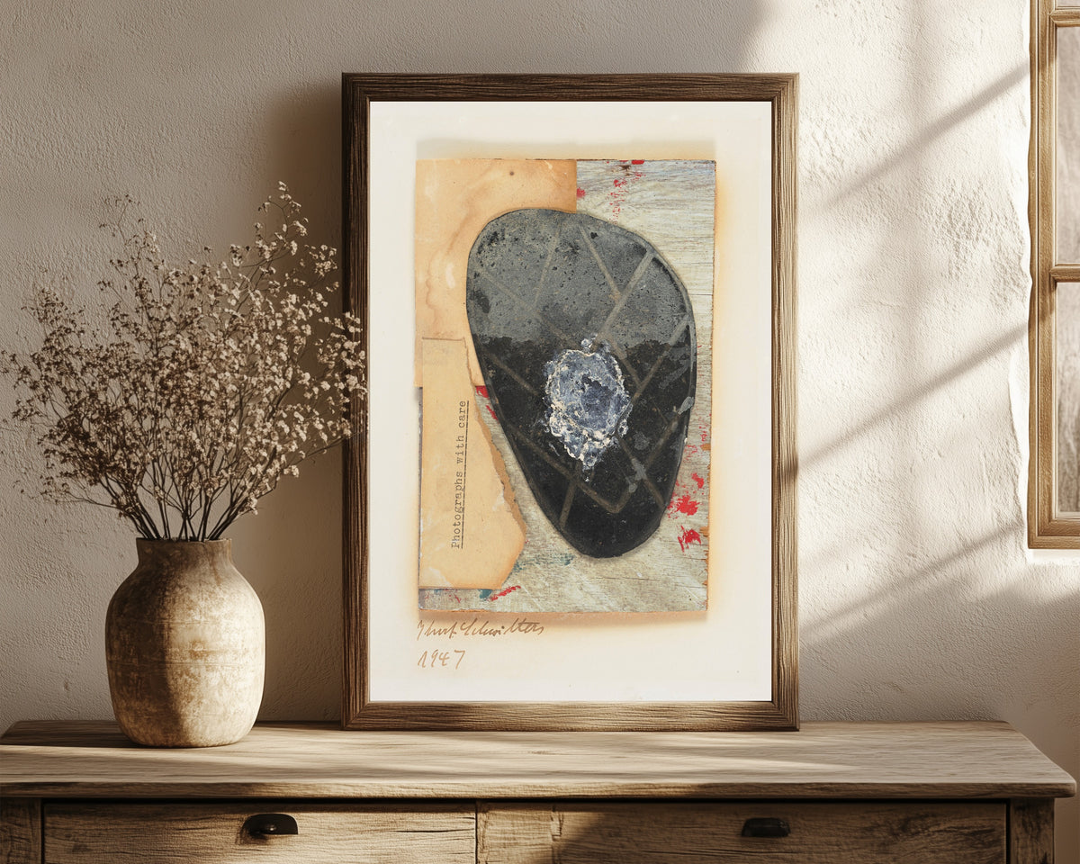 Framed art print of Ohne Titel (Fotografien mit Sorgfalt) by Kurt Schwitters, in a dark wood frame leaning on a rustic console beside dried flowers
