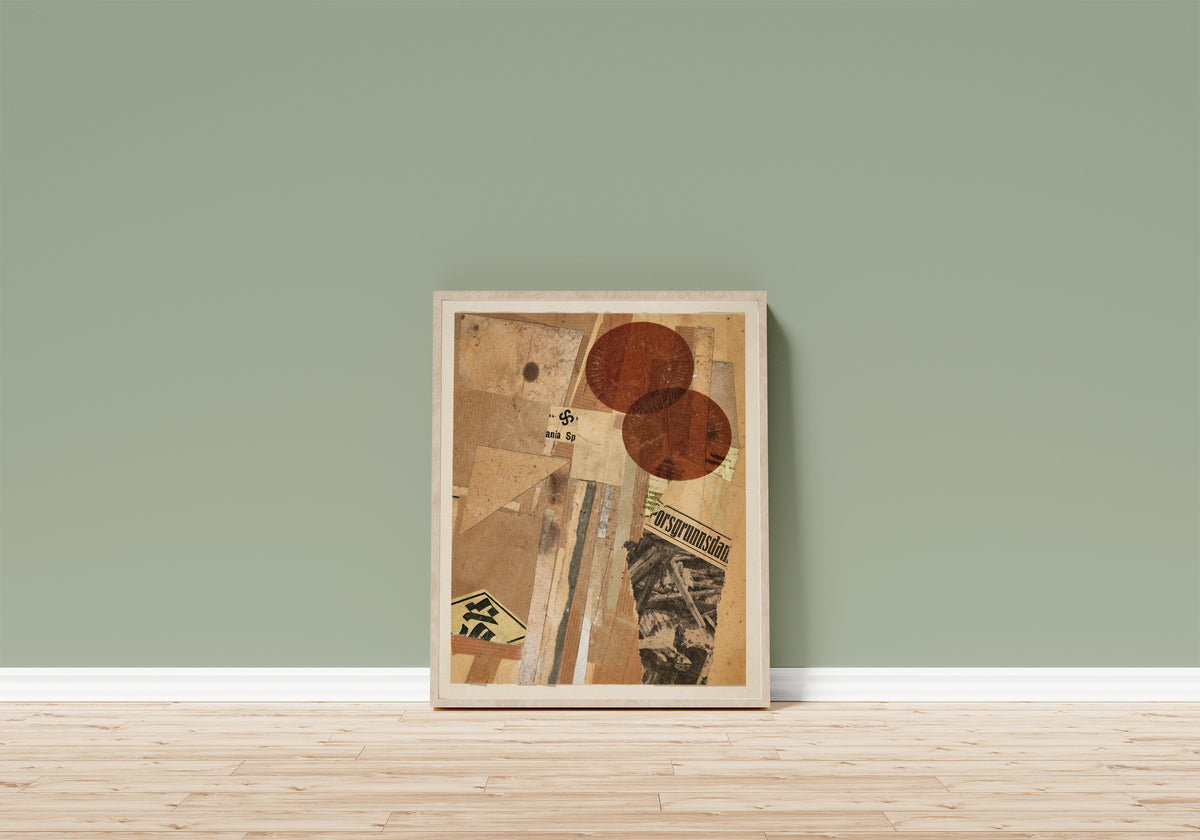 Framed art print of Ohne Titel (orsgrunnsdan) by Kurt Schwitters, in a light wood frame leaning on a sage green wall above a wooden floor