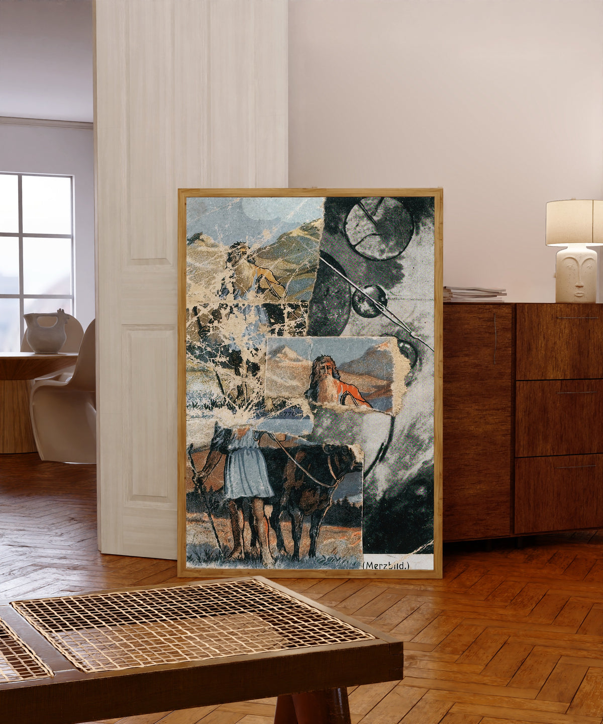 Framed art print of Sans Titre (Collagierte Bildpostkarte Das Kreisen) by Kurt Schwitters, in a light wood frame leaning in a warm room with a parquet floor