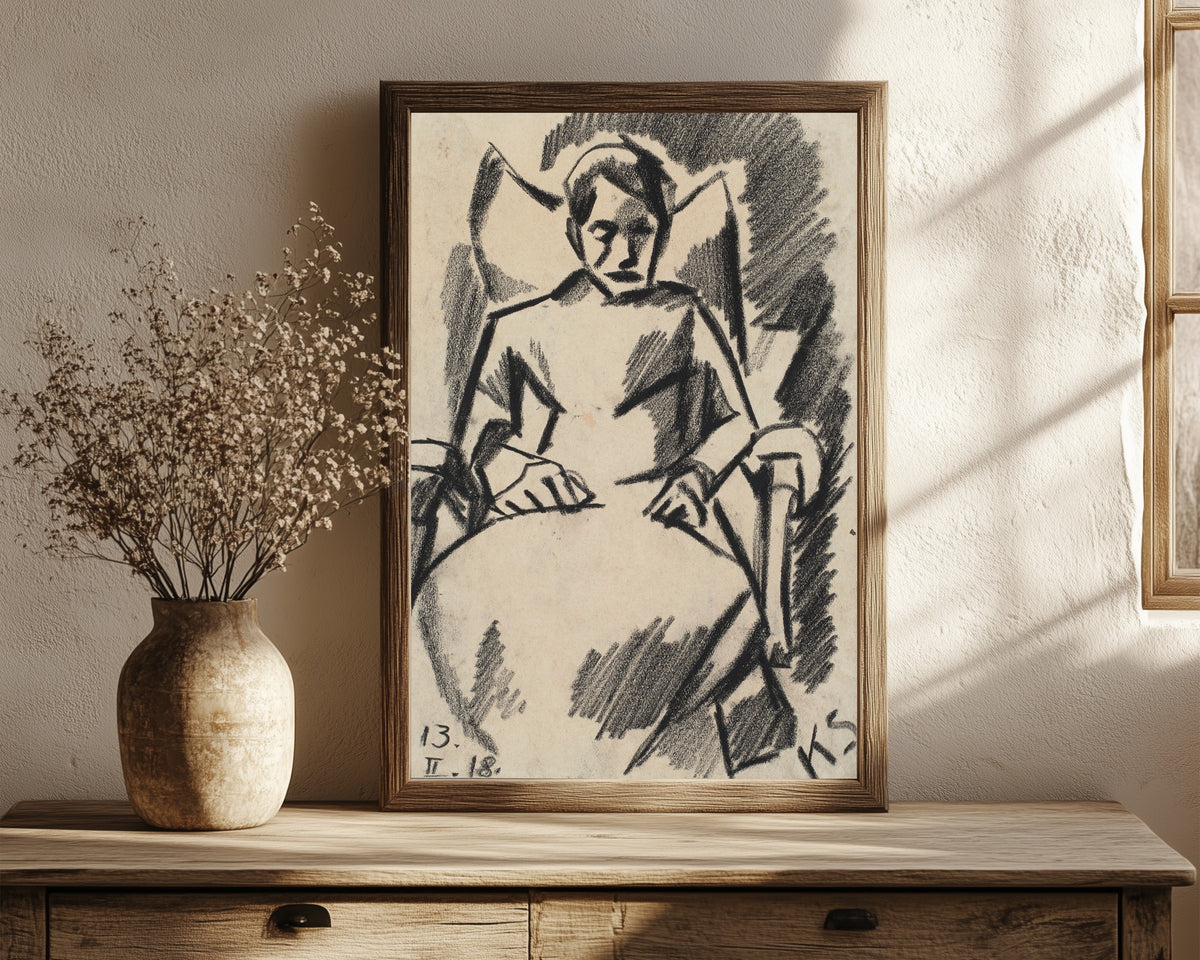 Framed art print of Z 112 Die Kranke by Kurt Schwitters, in a dark wood frame leaning on a rustic console beside dried flowers