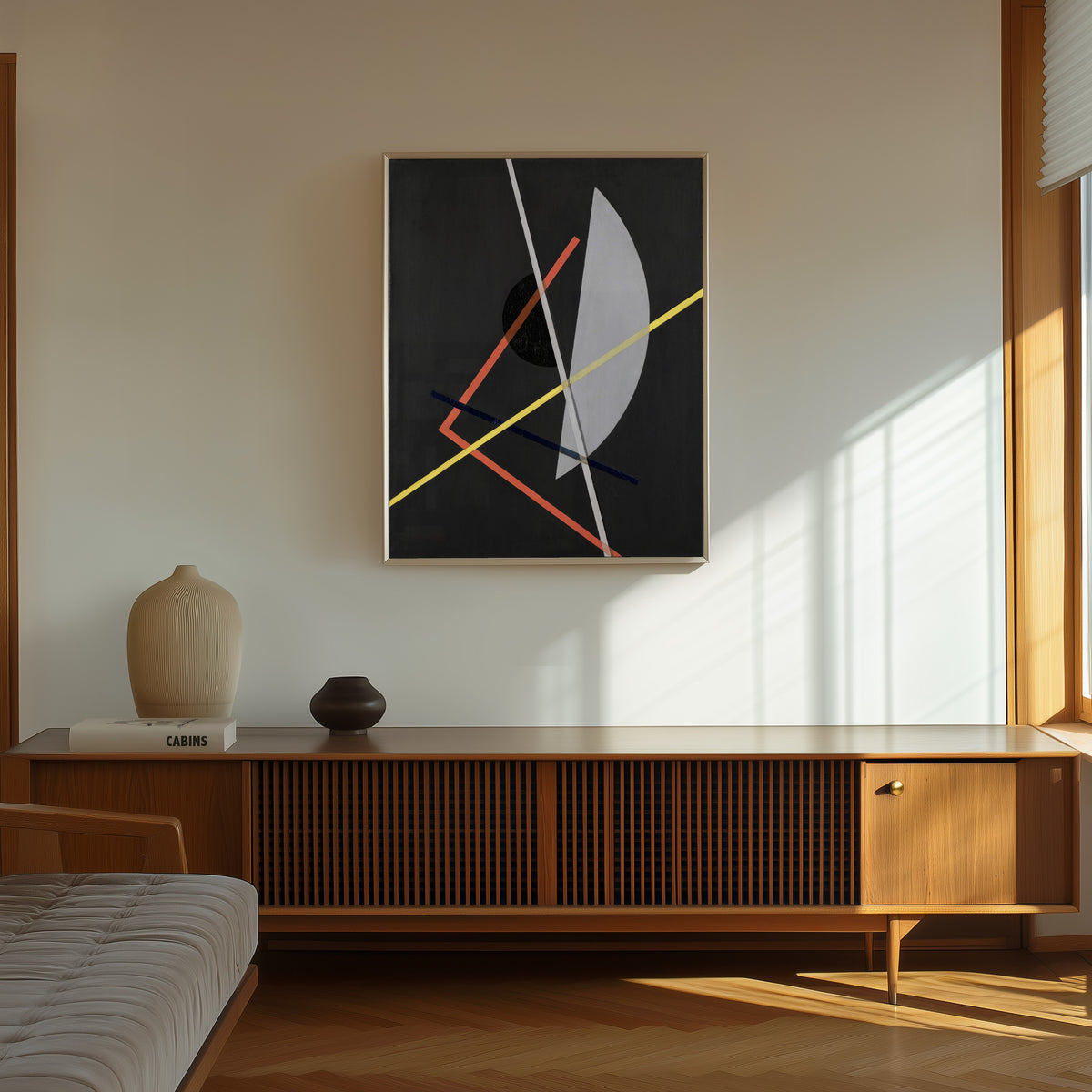 Framed art print of E IV (Konstruktion VII) by László Moholy-Nagy, in a thin light frame on a sunlit wall above a wooden sideboard