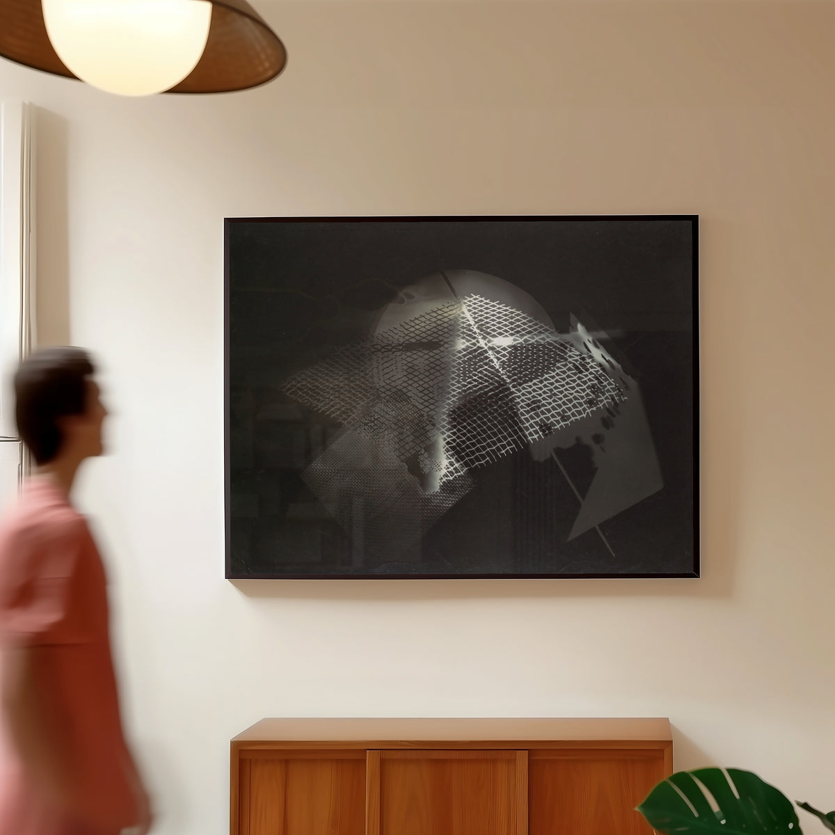 Framed art print of Fotogramm (1922) by László Moholy-Nagy, in a slim black frame on a warm wall in a sunlit room