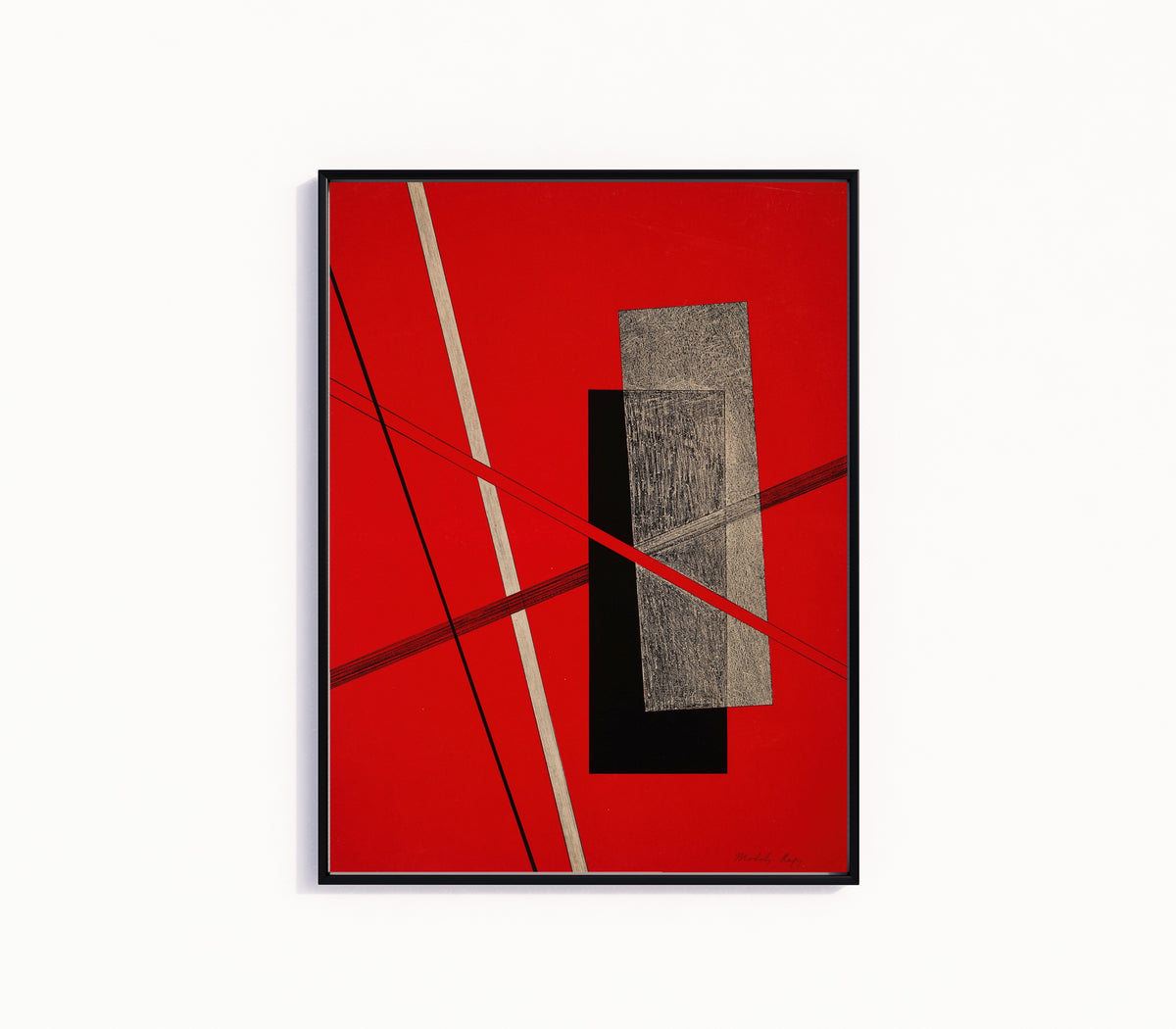 Framed art print of Konstruktion IV by László Moholy-Nagy, in a slim black frame on a plain white wall