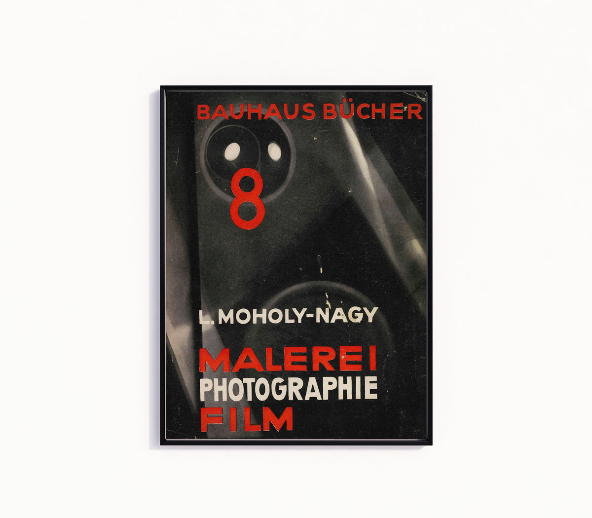 Framed art print of Malerei, Photographie, Film by László Moholy-Nagy, in a slim black frame on a plain white wall