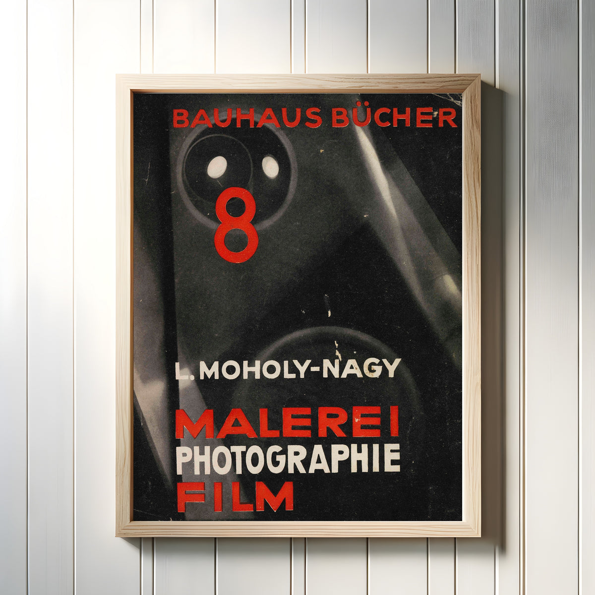 Framed art print of Malerei, Photographie, Film by László Moholy-Nagy, in a light wood frame on a white panelled wall