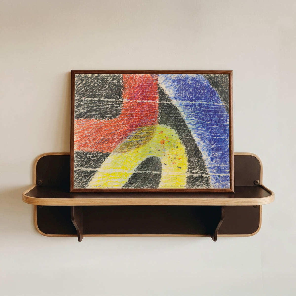 Framed art print of Untitled by László Moholy-Nagy, in a dark wood frame resting on a wall shelf