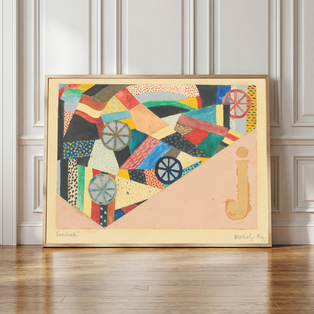 Framed art print of Untitled (J Under Fields, For Ernst Kállai) by László Moholy-Nagy, in a light wood frame leaning against a panelled white wall