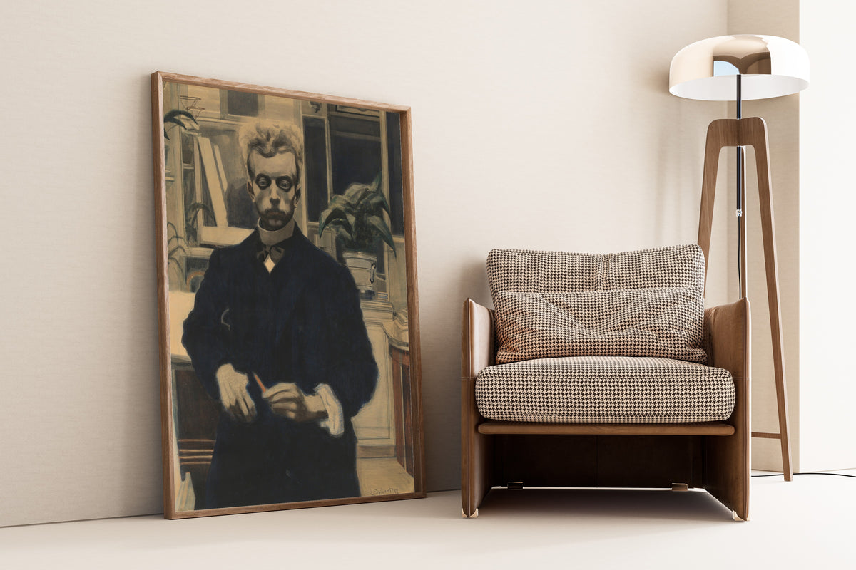 Framed art print of Self-Portrait with Red Pencil by Léon Spilliaert, leaning against a wall beside an armchair and a floor lamp