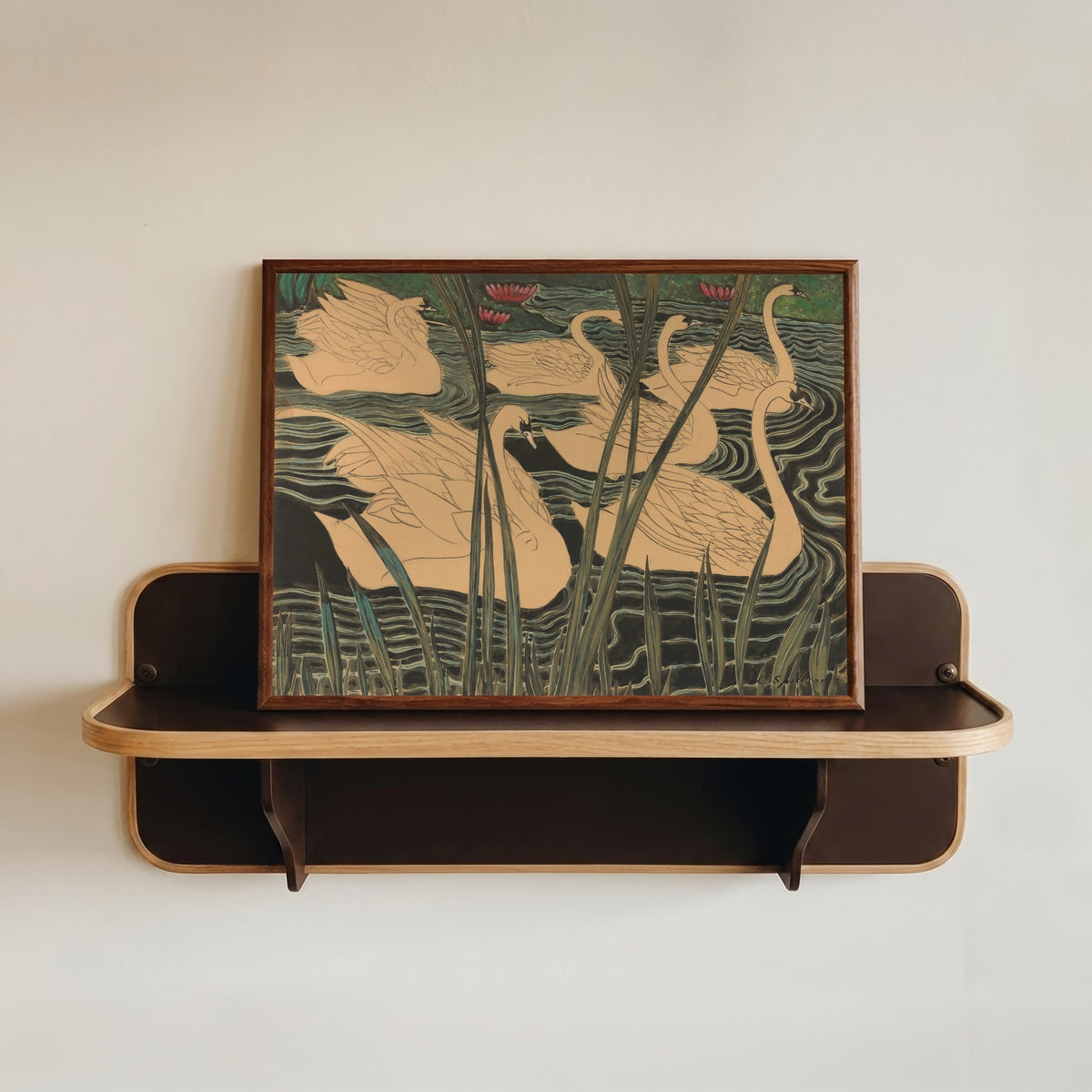 Framed art print of Zwanen by Léon Spilliaert, in a dark wood frame resting on a wall shelf