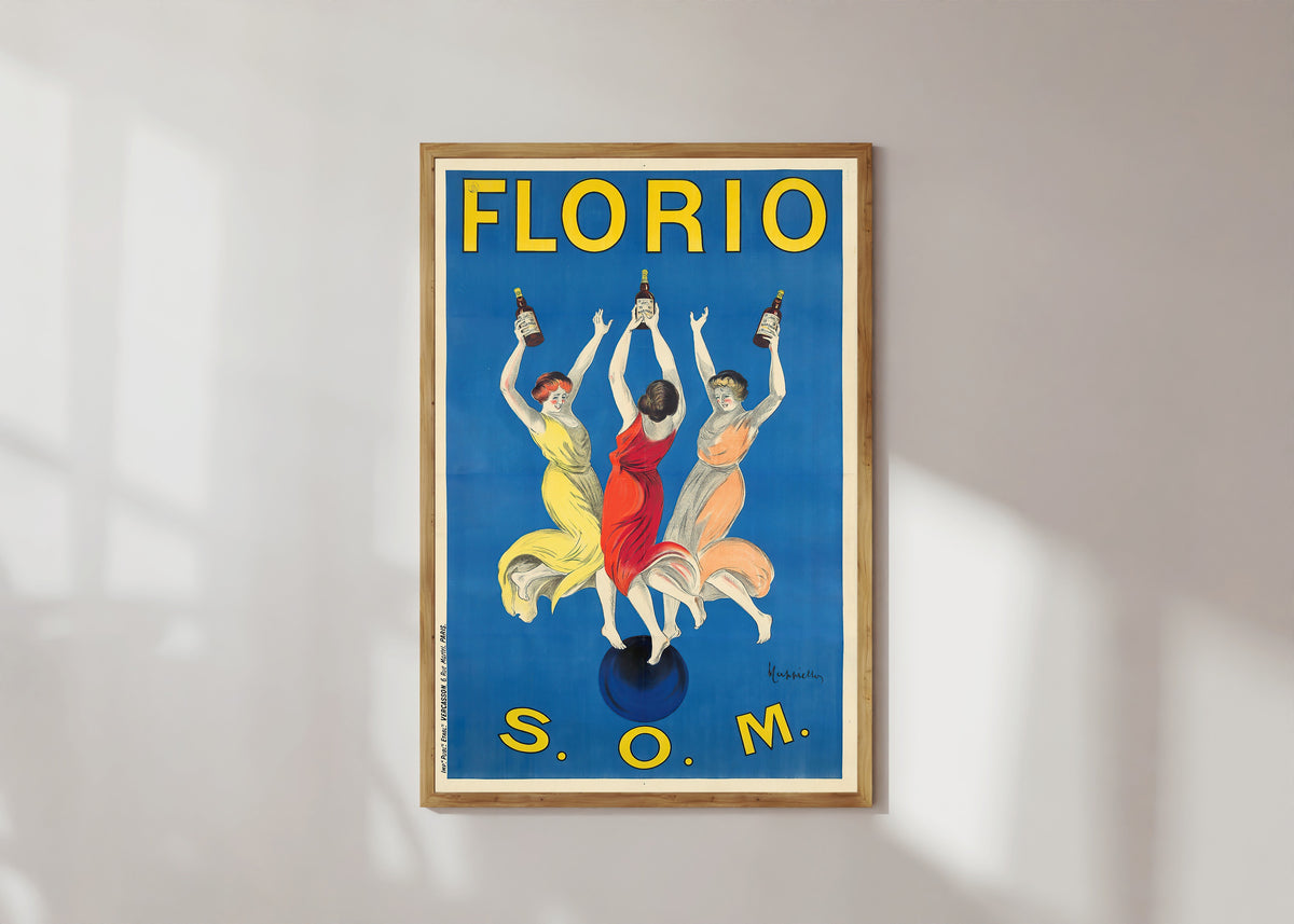 Framed art print of Florio S.O.M. by Leonetto Cappiello, in a light wood frame on a sunlit white wall