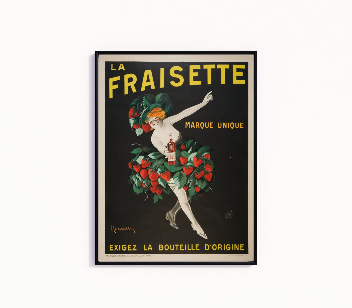 Framed art print of La Fraisette by Leonetto Cappiello, in a slim black frame on a plain white wall