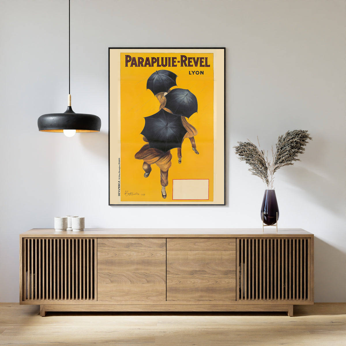 Parapluie-Revel by Leonetto Cappiello — framed above a slatted wood sideboard