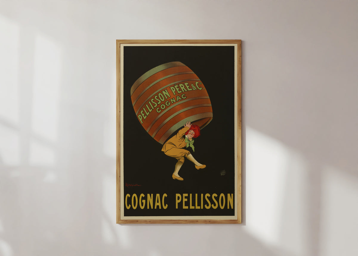 Framed art print of Pellisson père et Cie Cognac by Leonetto Cappiello, in a light wood frame on a sunlit white wall