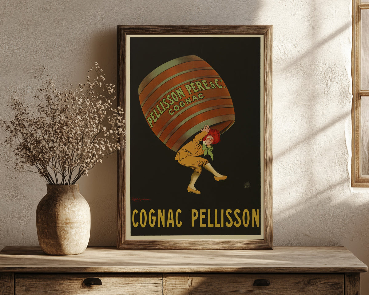 Framed art print of Pellisson père et Cie Cognac by Leonetto Cappiello, in a dark wood frame leaning on a rustic console beside dried flowers