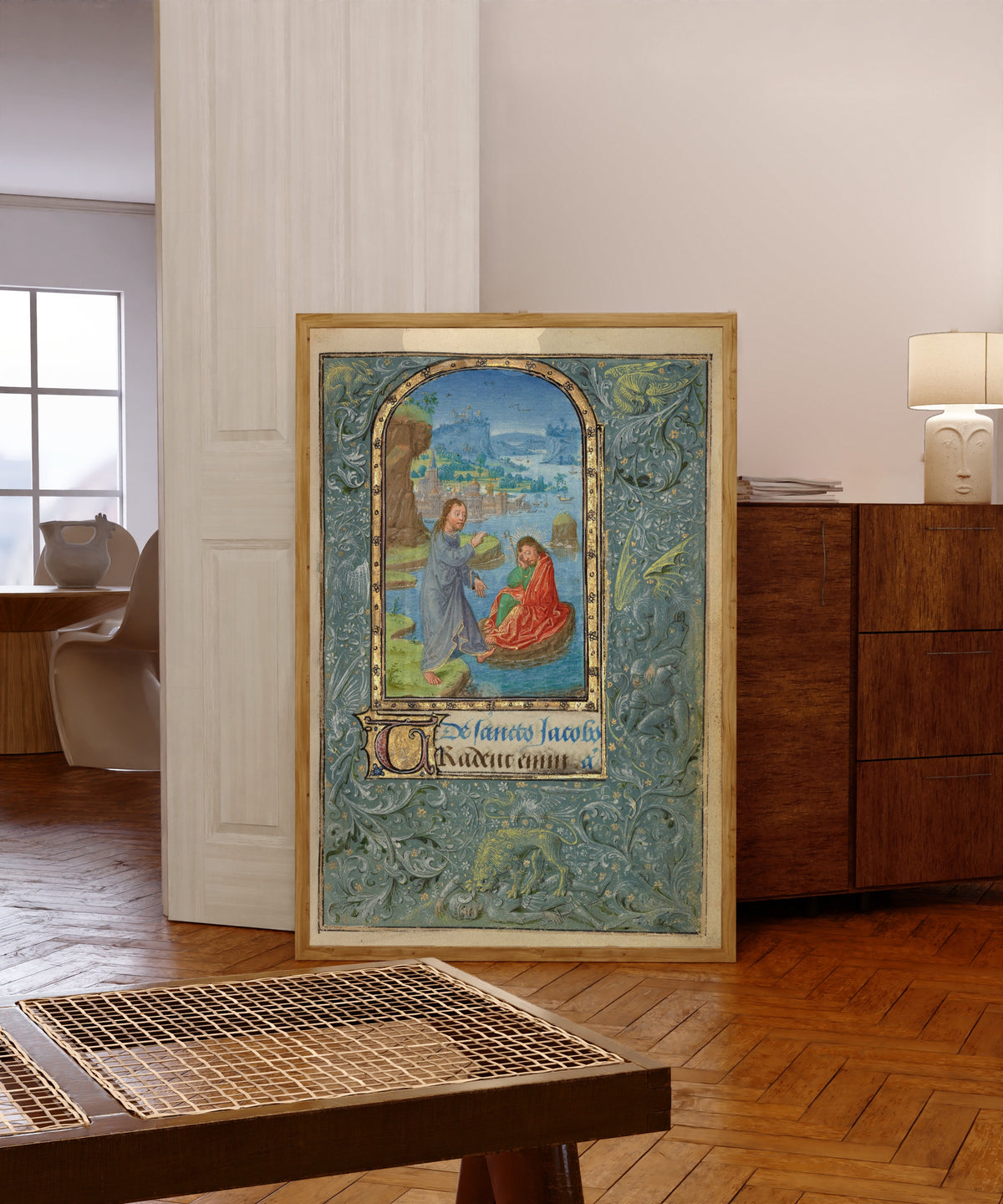 Framed art print of Prayer Book of Charles the Bold: Christ Appearing… by Lieven van Lathem, in a light wood frame leaning in a warm room with a parquet floor