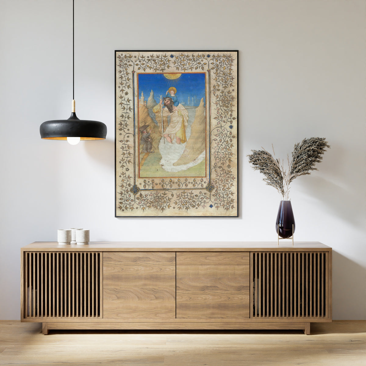 Framed art print of Saint Christopher Carrying the Christ Child by Limbourg Brothers, above a slatted wood sideboard