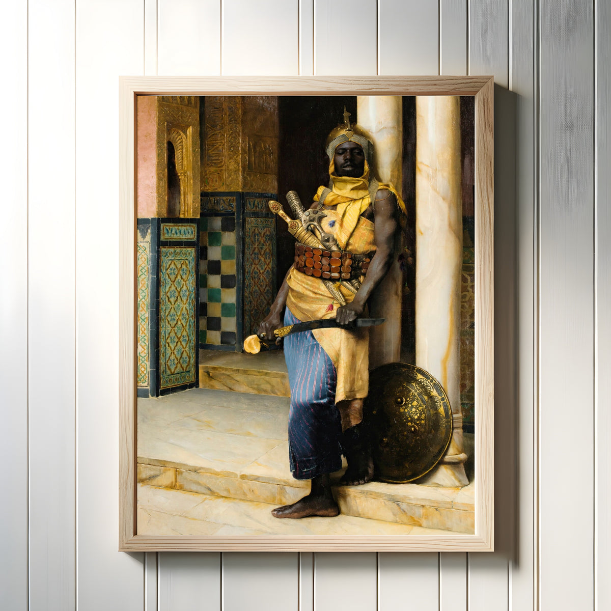 Framed art print of Guarding the Palace by Ludwig Deutsch, in a light wood frame on a white panelled wall