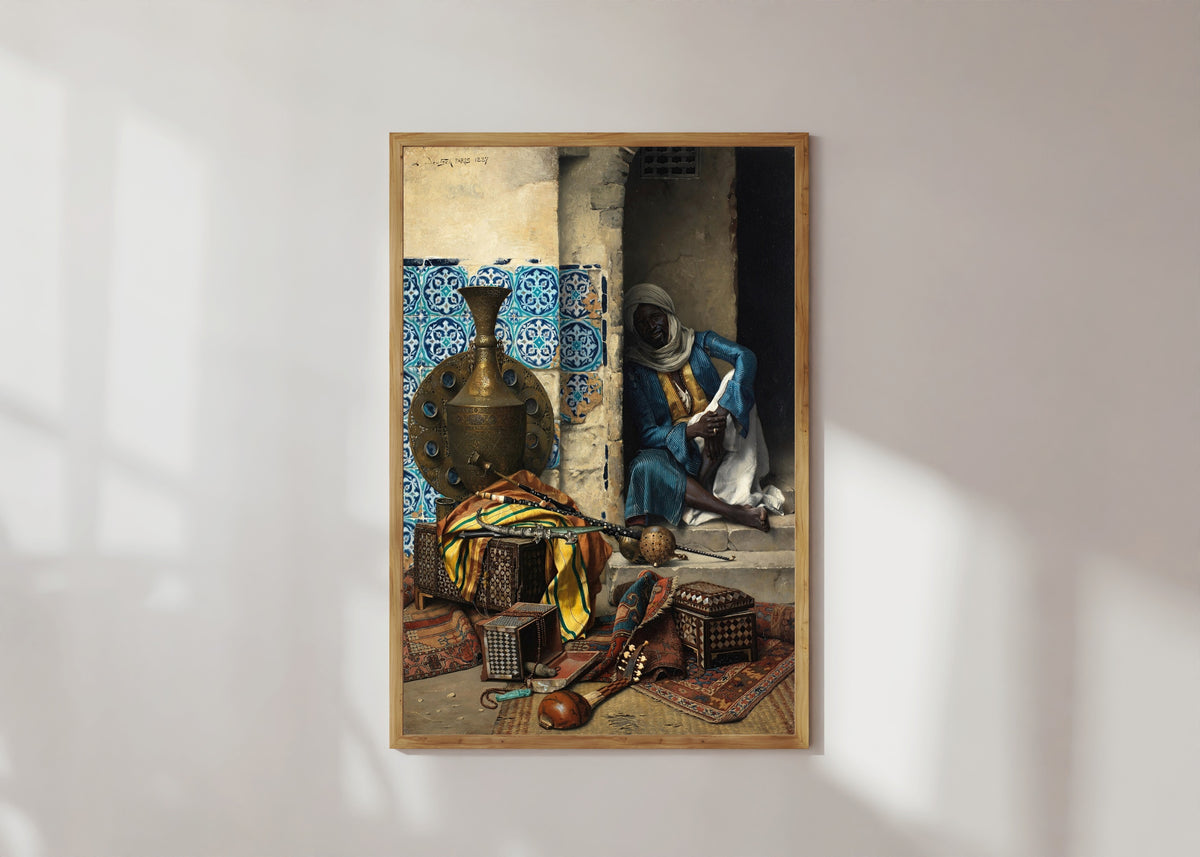 Framed art print of The Artefacts Dealer by Ludwig Deutsch, in a light wood frame on a sunlit white wall