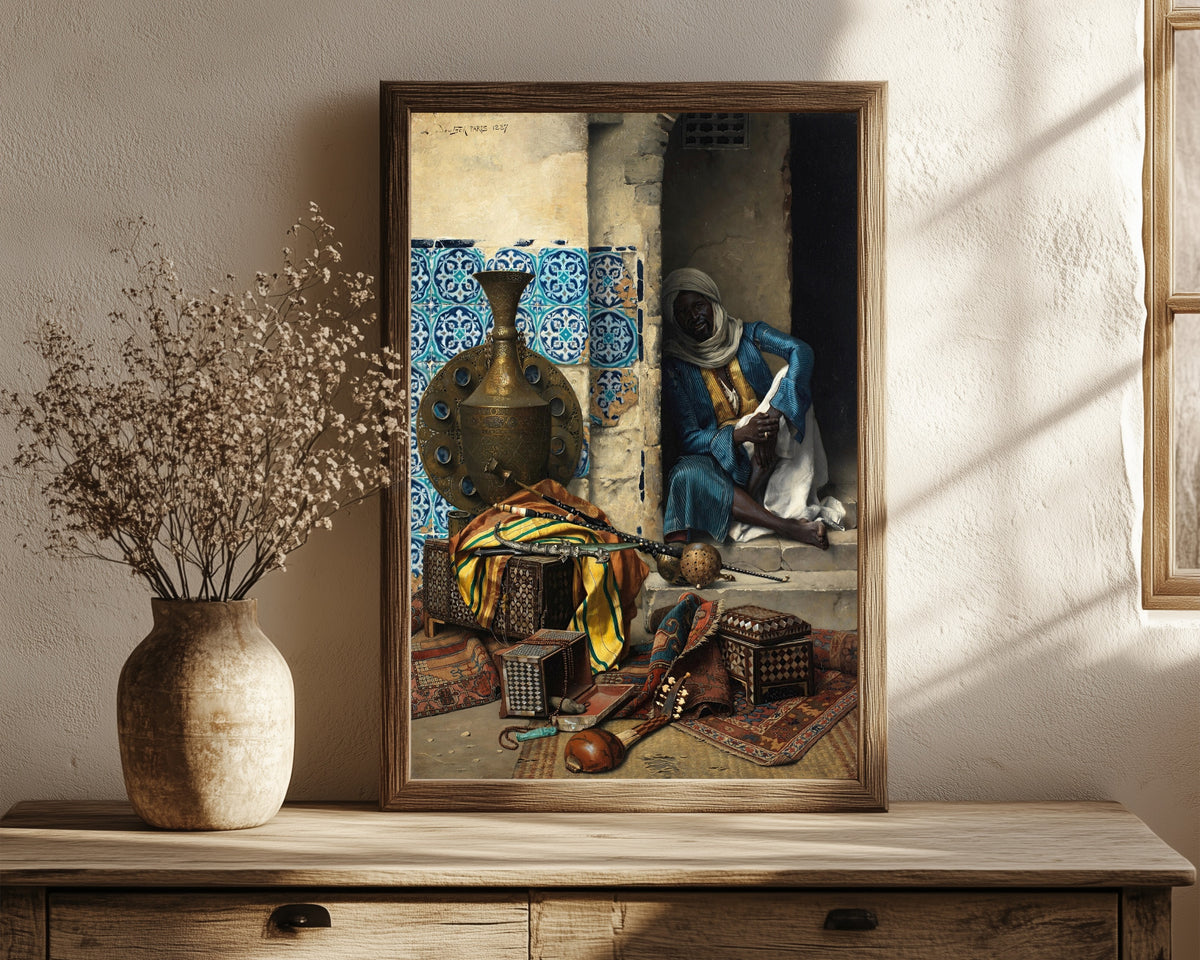 Framed art print of The Artefacts Dealer by Ludwig Deutsch, in a dark wood frame leaning on a rustic console beside dried flowers