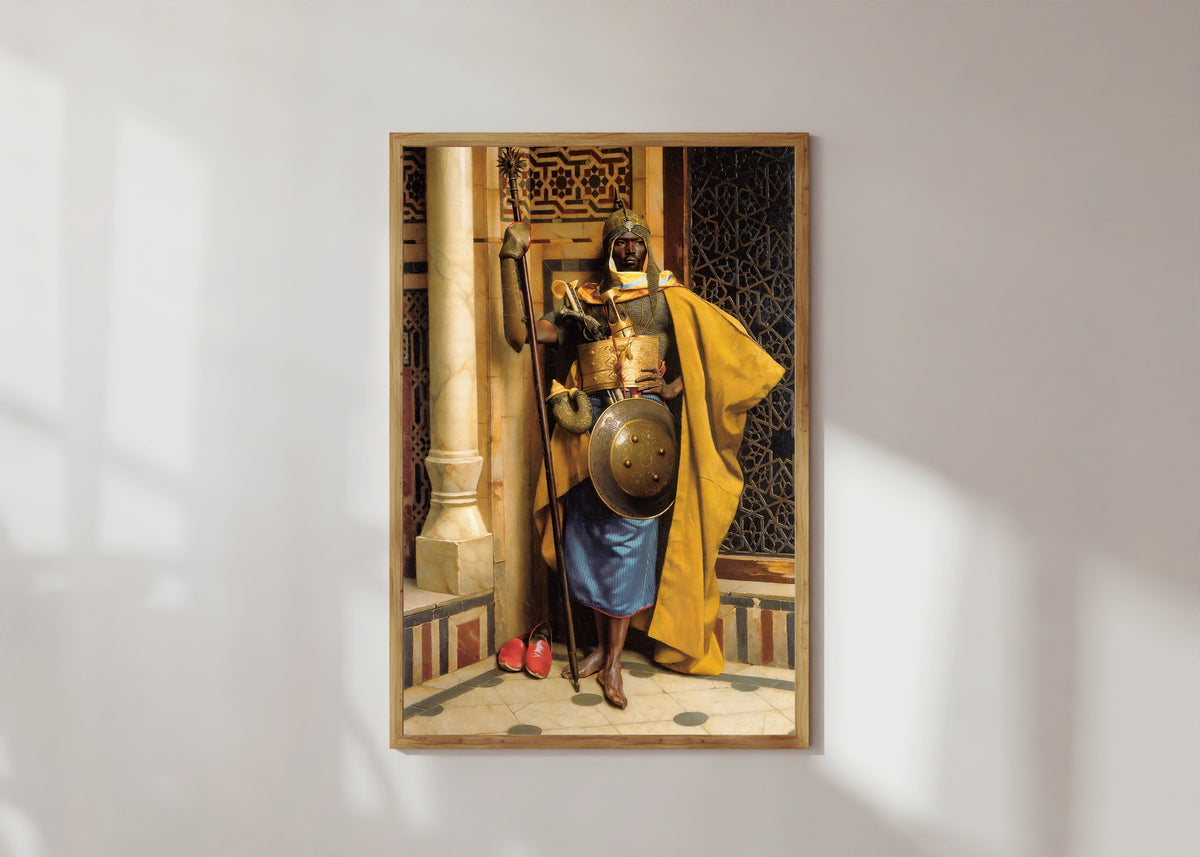 Framed art print of The Moorish Guard by Ludwig Deutsch, in a light wood frame on a sunlit white wall